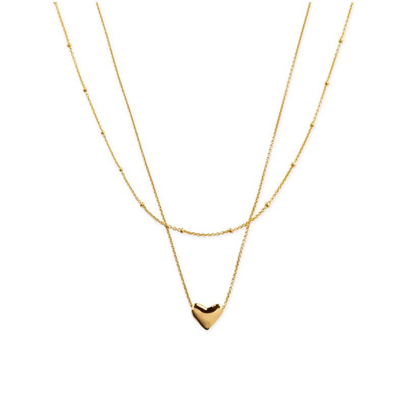 A gold necklace set with a heart by Monica Vinader