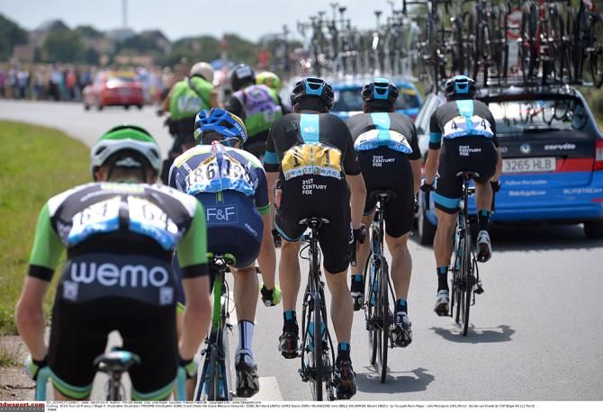 Team Sky pace defending Tour champion Chris Froome back up to the peloton after a crash