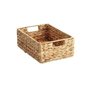 A smmall woven basket with handles on a white background