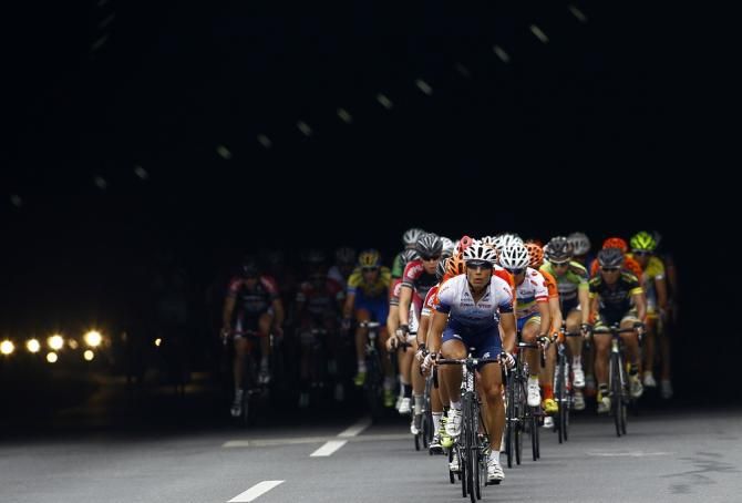 Riders emerge from a tunnel on stage 6
