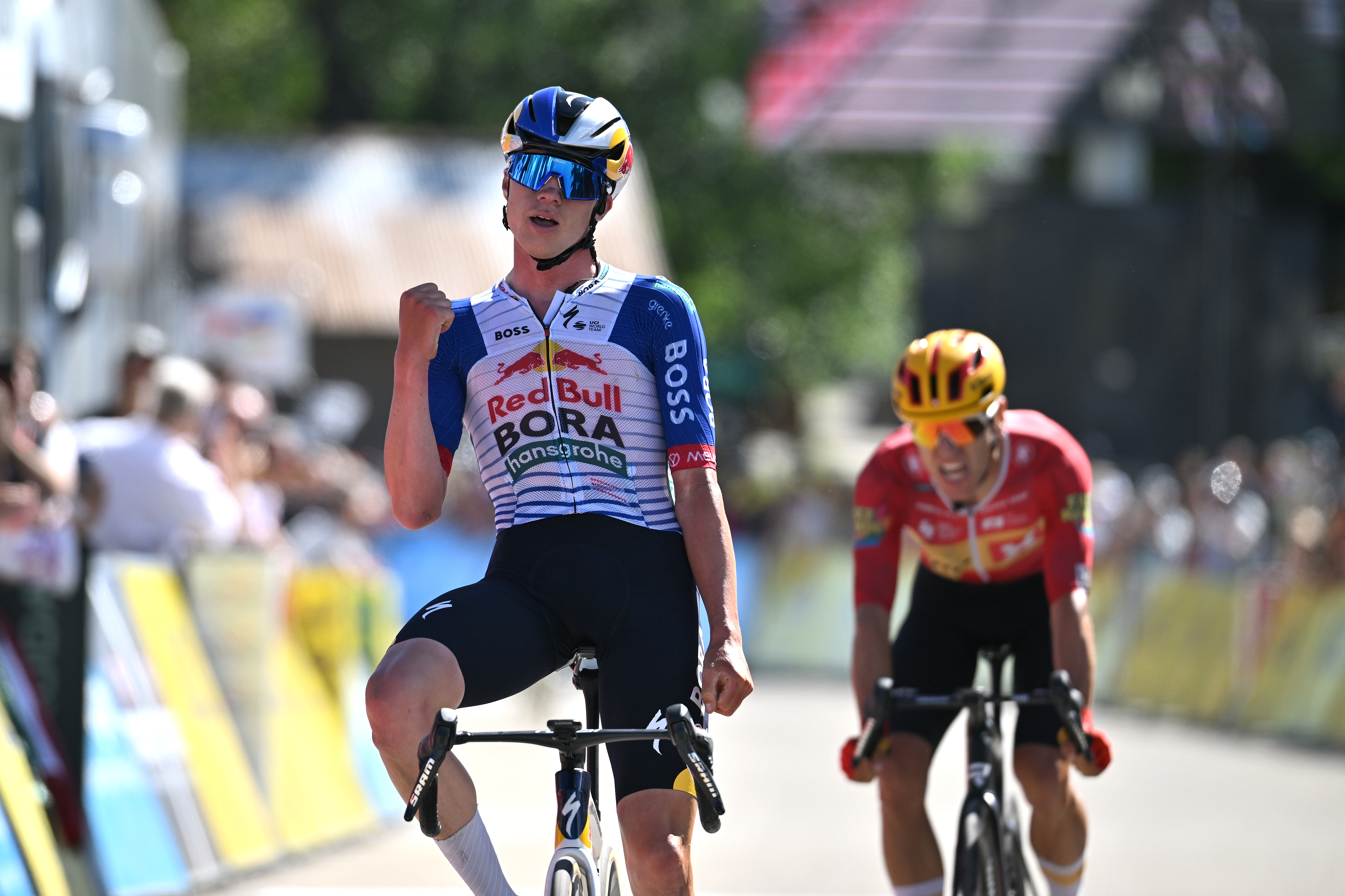 Maxim Van Gils raises one fist against his chest in celebration