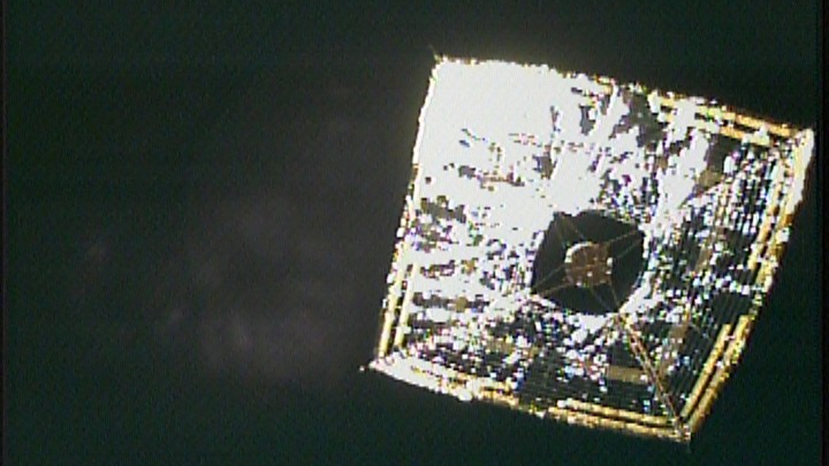 photo of a shiny silver square solar sail in deep space