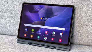 The Samsung Galaxy Tab S7 FE propped up with its keyboard case folded behind it