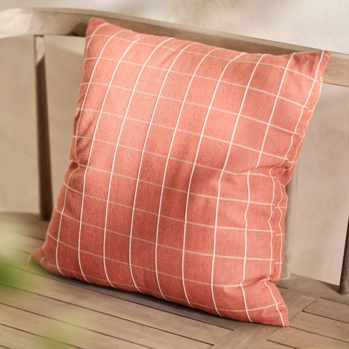 A coral cushion with white stripes