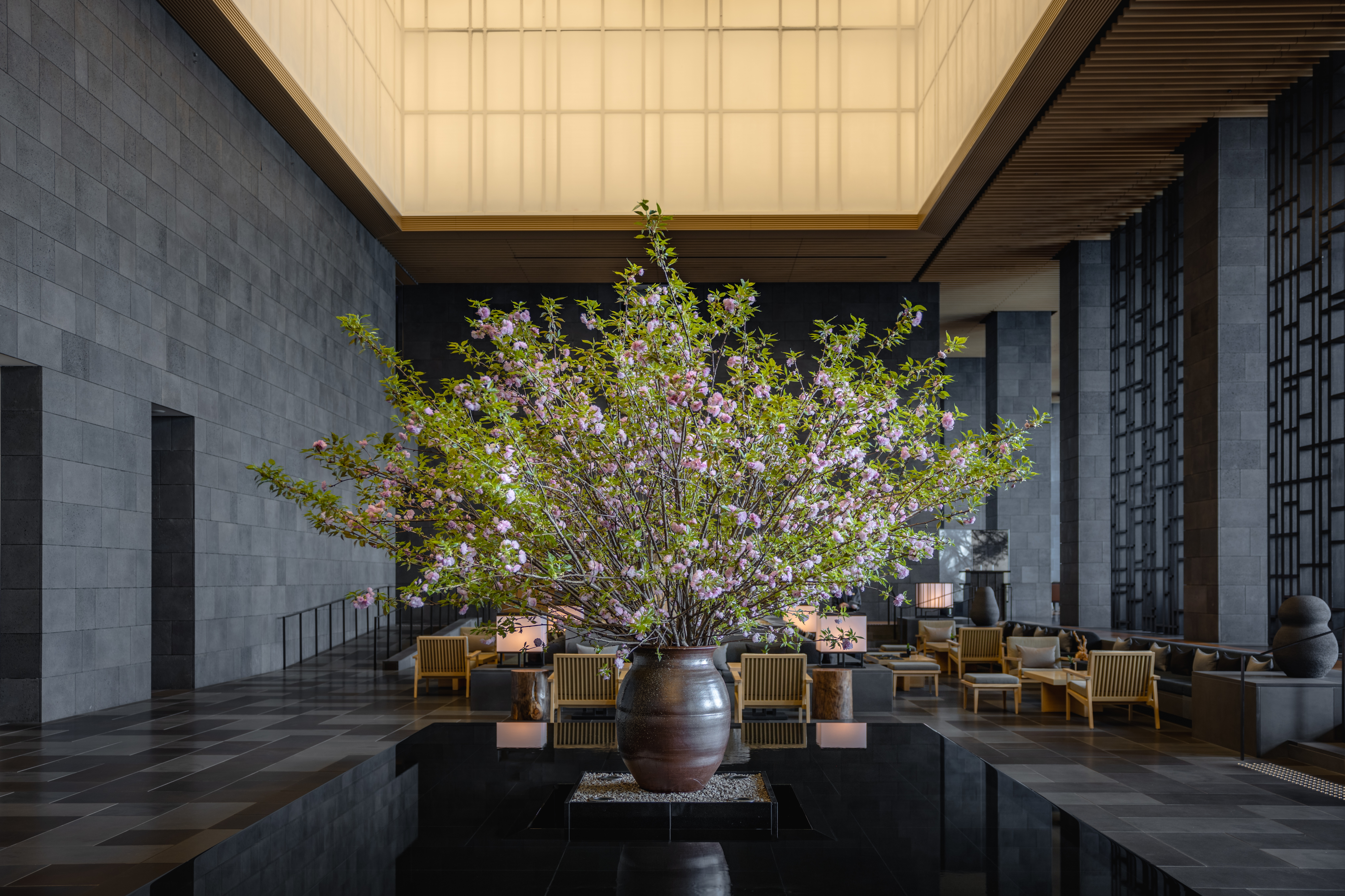 view of a serene hotel in tokyo, adorned with wooden furnishing, washi paper and natural stone touches