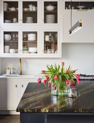 how to create more storage in a small kitchen with white cabinets and a black island