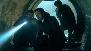 Dilan, Cassian, and Enza searching for something in a tunnel in Andor season 2