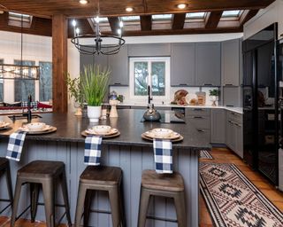 blue kitchen with island and rug