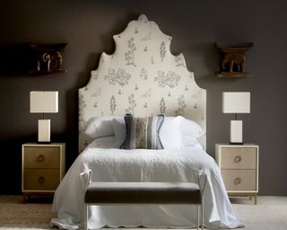 a tall detailed headboard in a bedroom