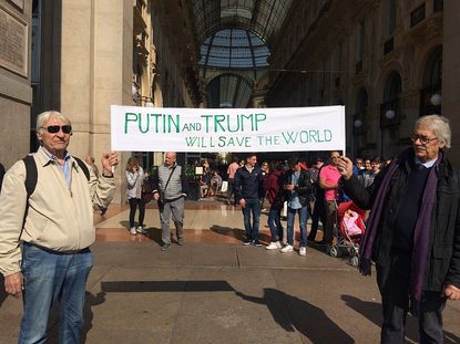 Vladimir Putin and Donald Trump supporters are seen on October 7, 2016 in Milan, Italy.