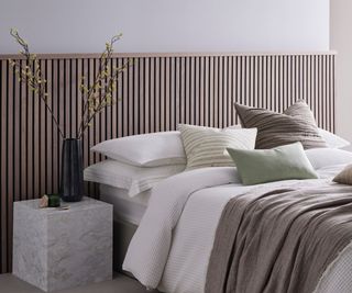 half height thin slatted wooden panelling behind bed