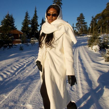 Nnenna Echem in a white coat and leather gloves