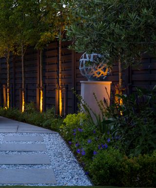 uplit trees and garden path