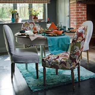 dining room with chairs and flower pot
