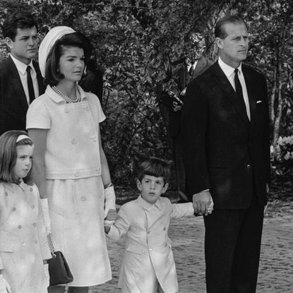 Jackie Kennedy, widow of assassinated US President John F. Kennedy, with her children Caroline and John F. Kennedy Jr., who held hands with Prince Philip at Runnymede for The Kennedy Memorial Stone ceremony May 14, 1965
