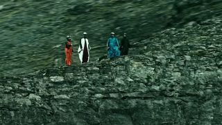 4 people standing on a cliff in Point Break