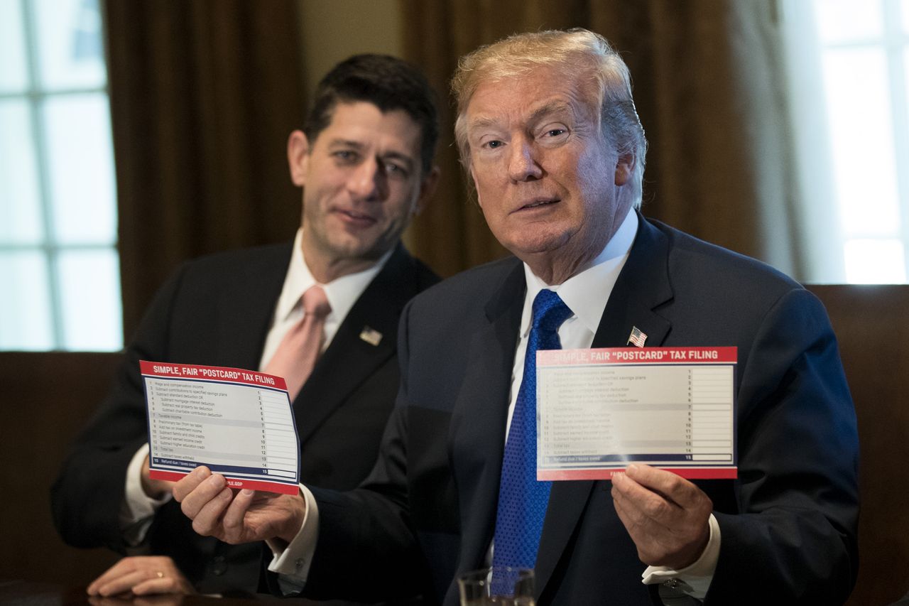 President Trump holds the GOP&amp;#039;s tax reform postcard.