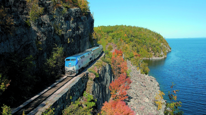 Vegetation, Coastal and oceanic landforms, Coast, Natural landscape, Rolling stock, Railway, Terrain, Slope, Azure, Railroad car, 