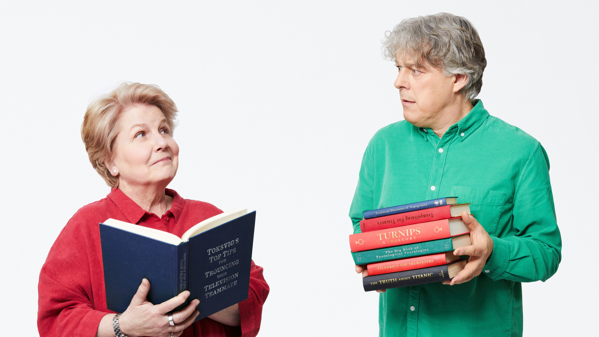 Sandi Toksvig, Alan Davies holding books for QI