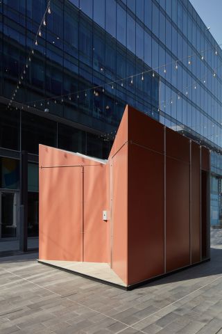 Orange pavilion installed in Dubai's design district, created by Anarchitect with Cosentino