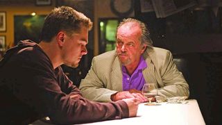(L to R) Leonardo DiCaprio and Jack Nicholson sitting at a table in The Departed