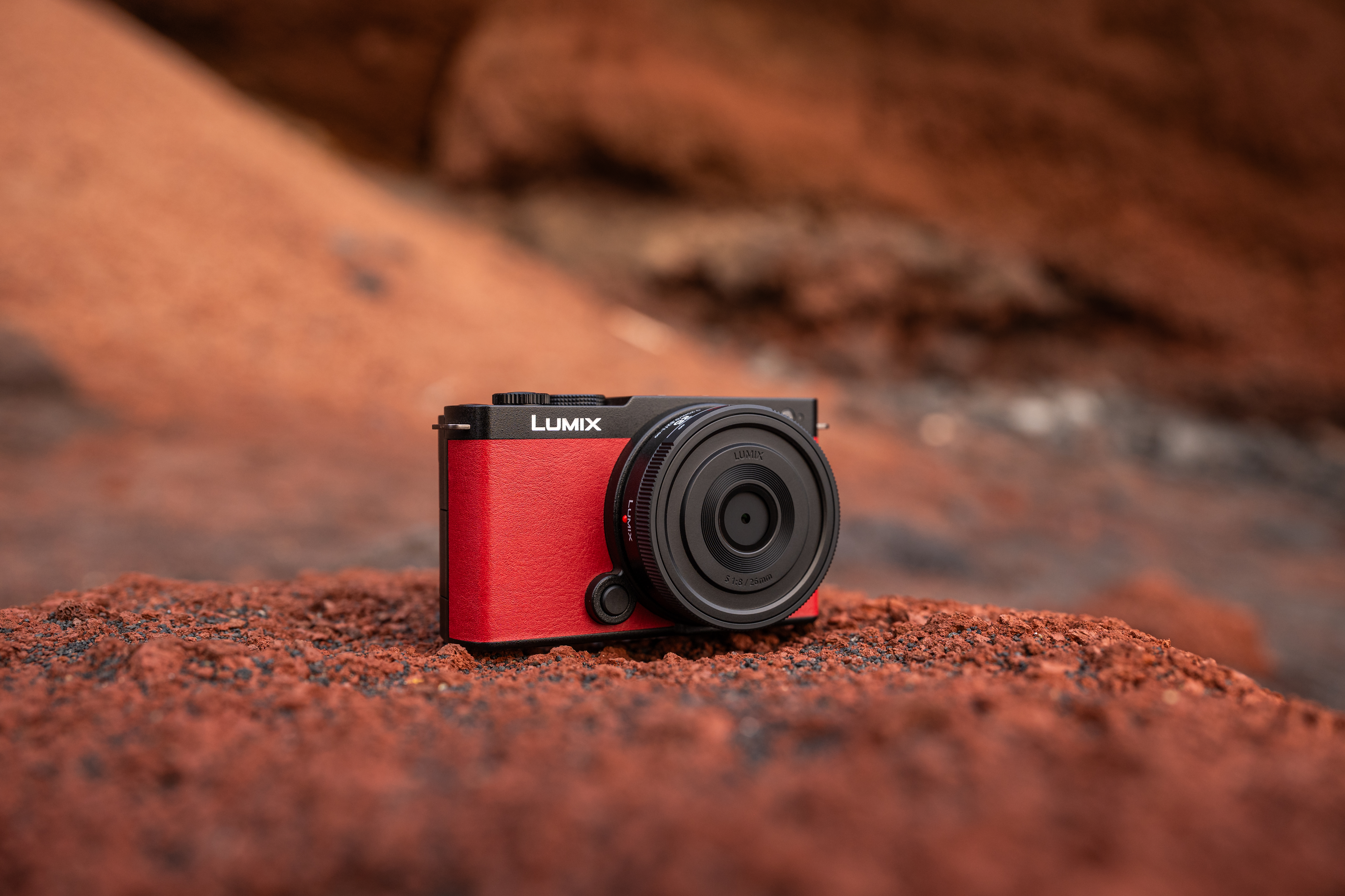 A red LUMIX S9 sitting in a rocky environment