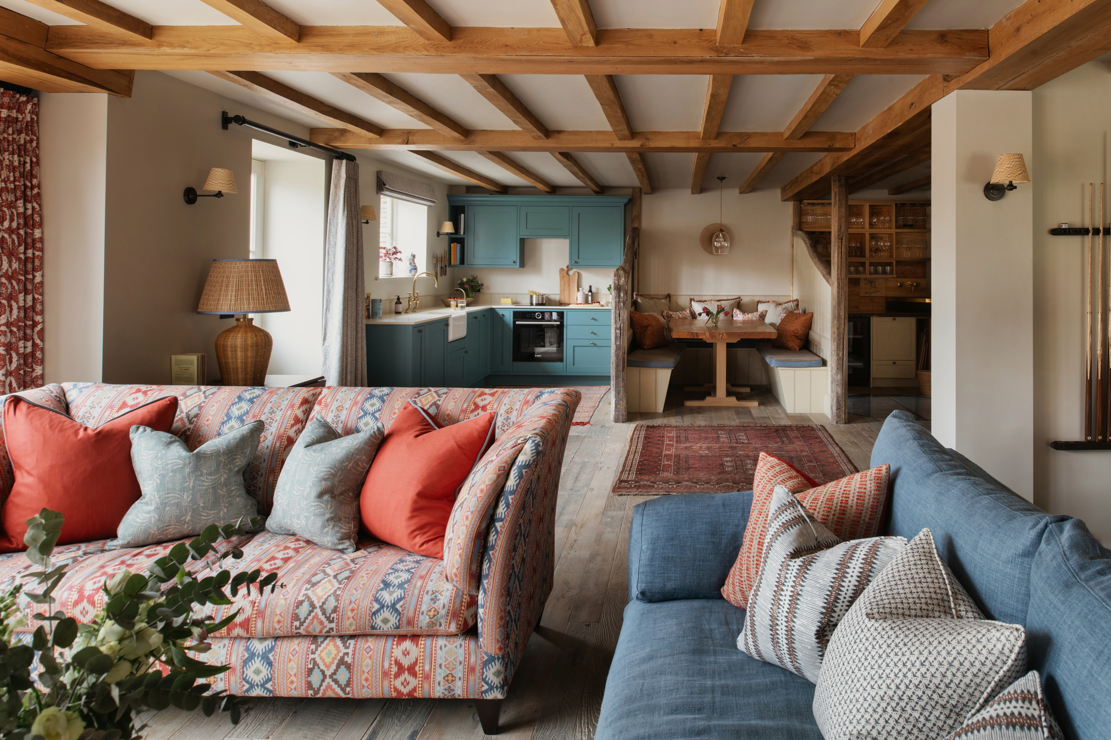 The farmhouse style interior of Monxton, with blues, reds, and natural wood finishes throughout.