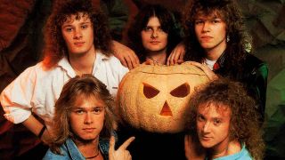 Helloween posing for a photograph with a giant pumpkin in 1988