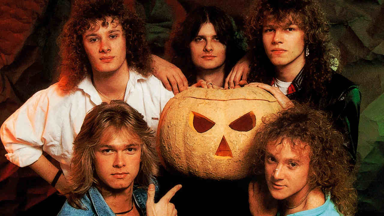Helloween posing for a photograph with a giant pumpkin in 1988