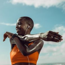 A woman stretching after doing one of the best outdoor workouts