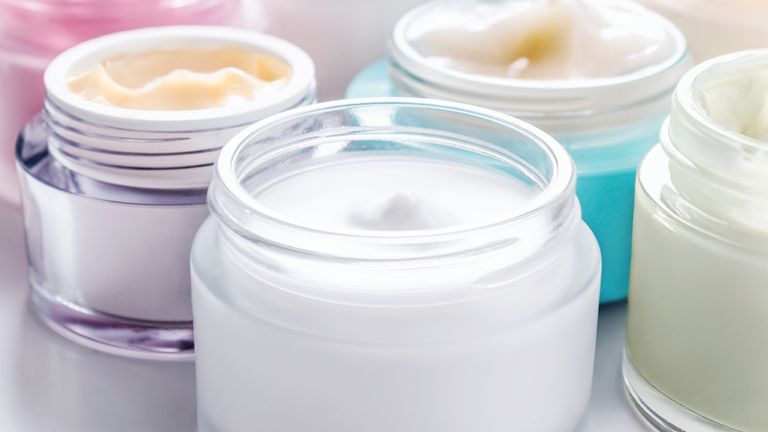 Close up of various jars of white skincare cream