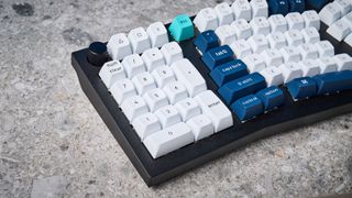 A black Keychron Q14 Max Alice keyboard with white, blue and teal keycaps