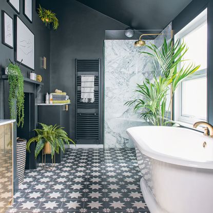 Blue bathroom with white bath and shower enclosure and patterned tiles