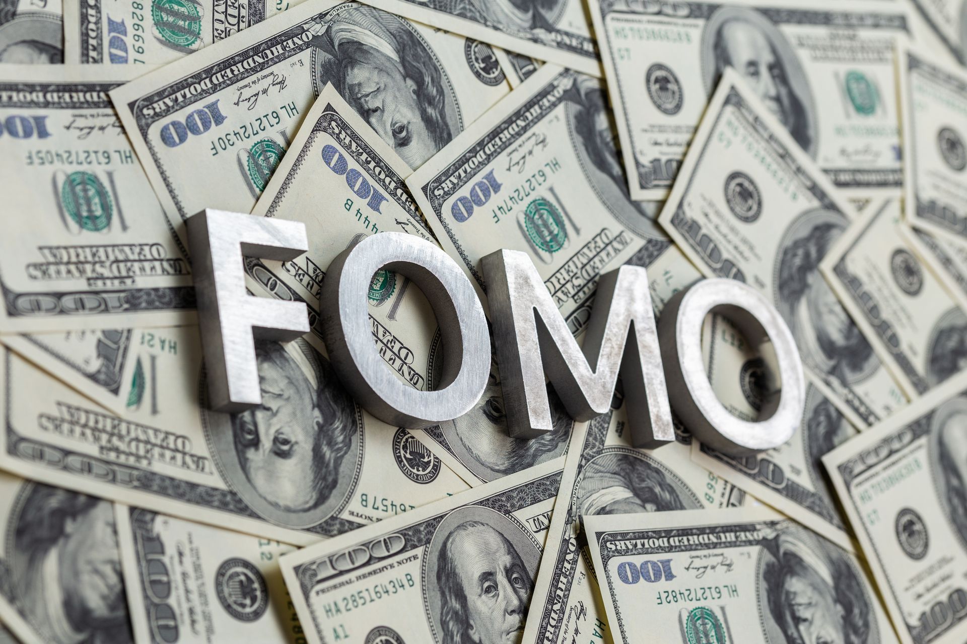 FOMO text on paper dollars.