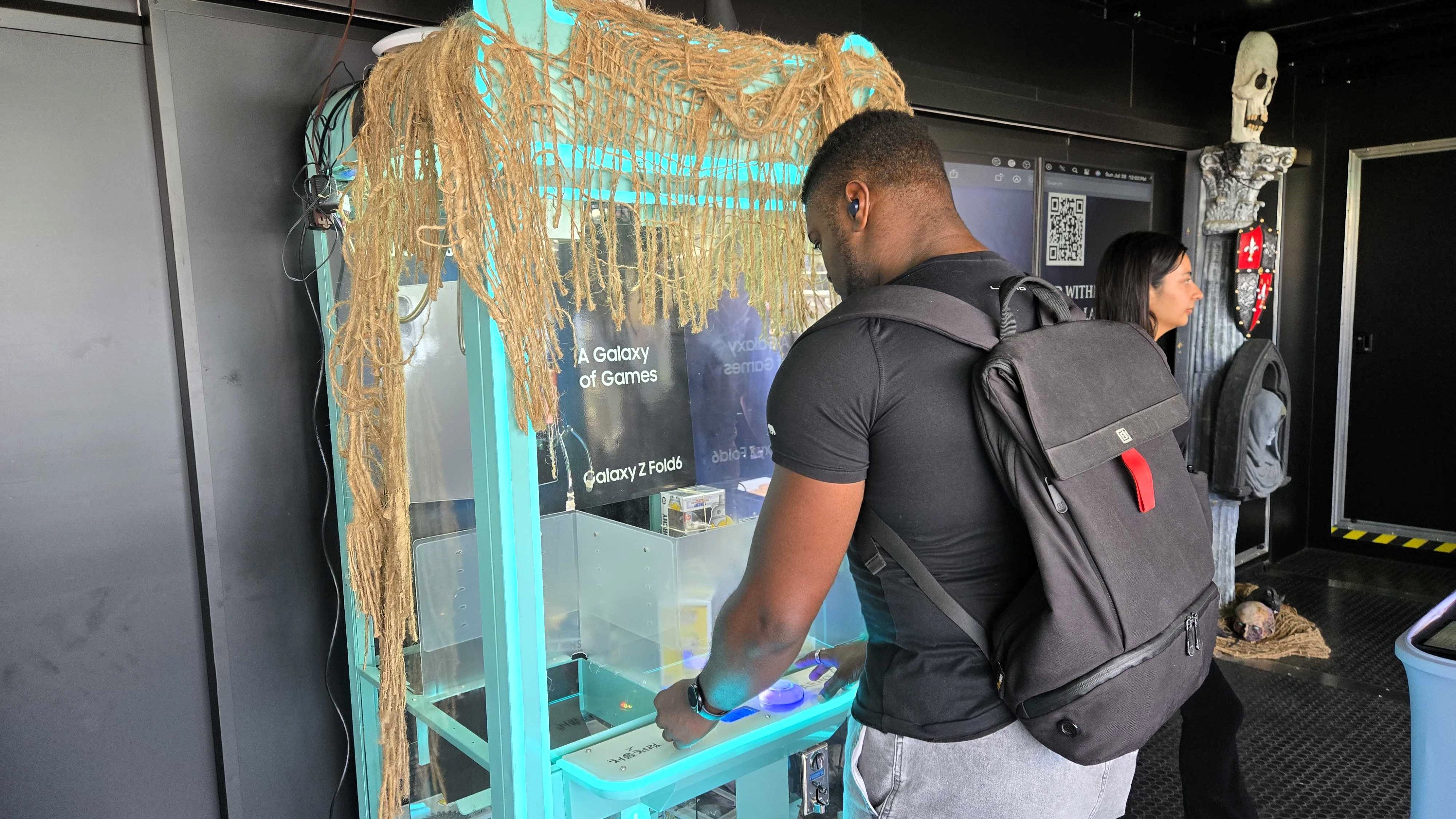 Playoing the claw machine at Samsung's Comic-Con booth