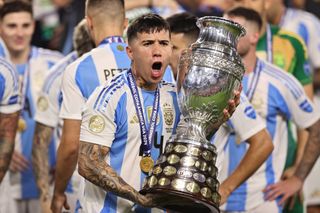 Enzo Fernandez celebrates with the Copa America trophy after Argentina's win over Colombia in July 2024.