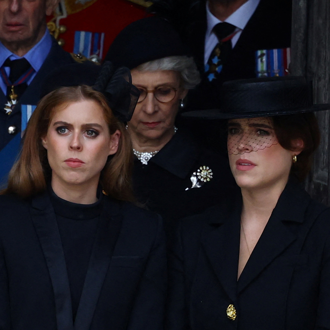 Princess Beatrice and Princess Eugenie both look serious while wearing black outfits