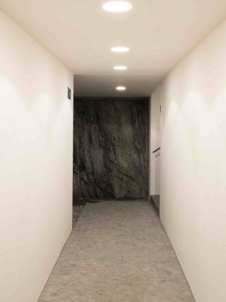 White hallway with cave at the end