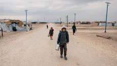 Residents walk through al-Hol camp