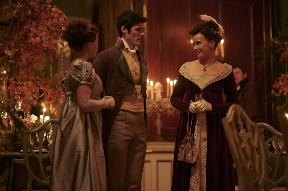 Charlotte (Rose Williams), Ralph (Cai Brigden) and Lady Susan (Sophie Winkleman) stand in conversation at Georgiana&#039;s party