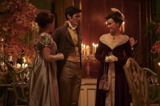 Charlotte (Rose Williams), Ralph (Cai Brigden) and Lady Susan (Sophie Winkleman) stand in conversation at Georgiana's party
