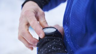 Skier checks smartwatch