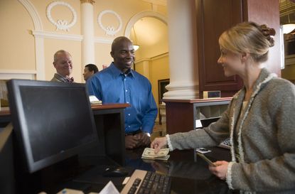 Man waiting in line for bank teller