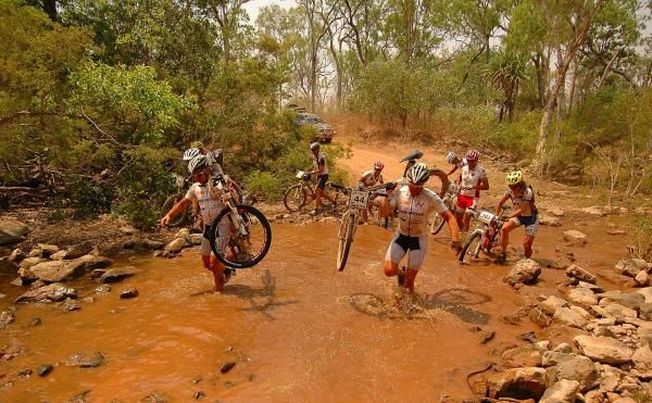 Team Sunprint riders keep their bikes dry at a creek crossing