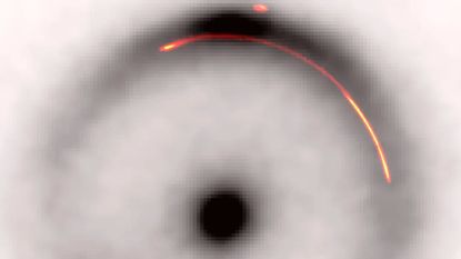 A black and white image of an Einstein ring with a red a yellow arc highlighted within its halo