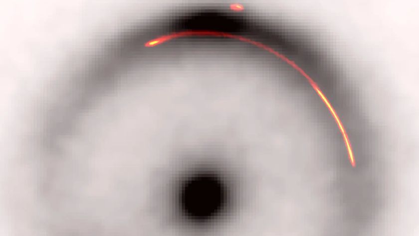 A black and white image of an Einstein ring with a red a yellow arc highlighted within its halo