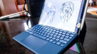 HP Chromebook x2 on a table with art sketch on display
