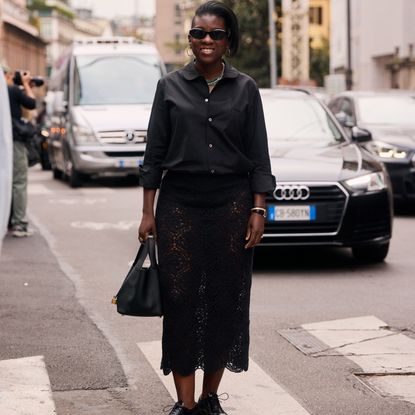 nikki ogunnaike wearing a button-down and a lace skirt 