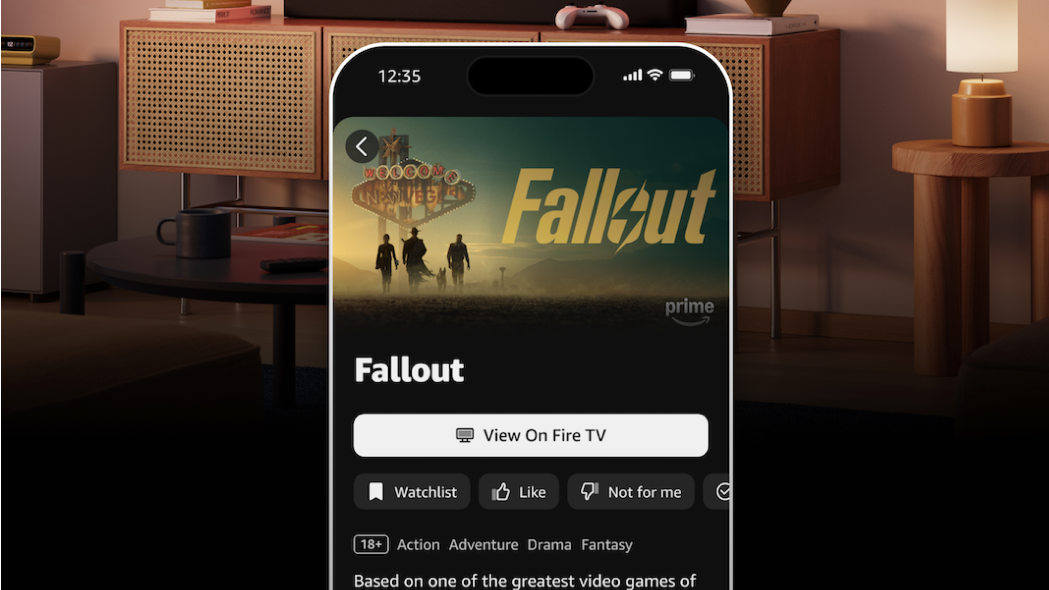 A photo of the Fire TV mobile app showing information and options for the Fallout TV show. A living room and tv is blurred in the background of the photo