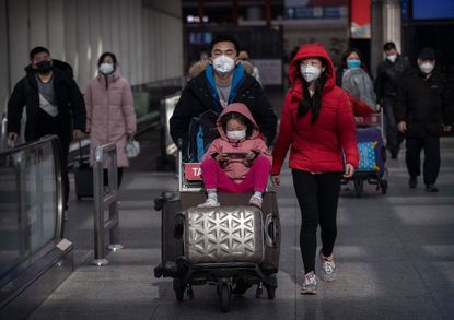 Travelers wear masks to protect themselves from Wuhan coronavirus.